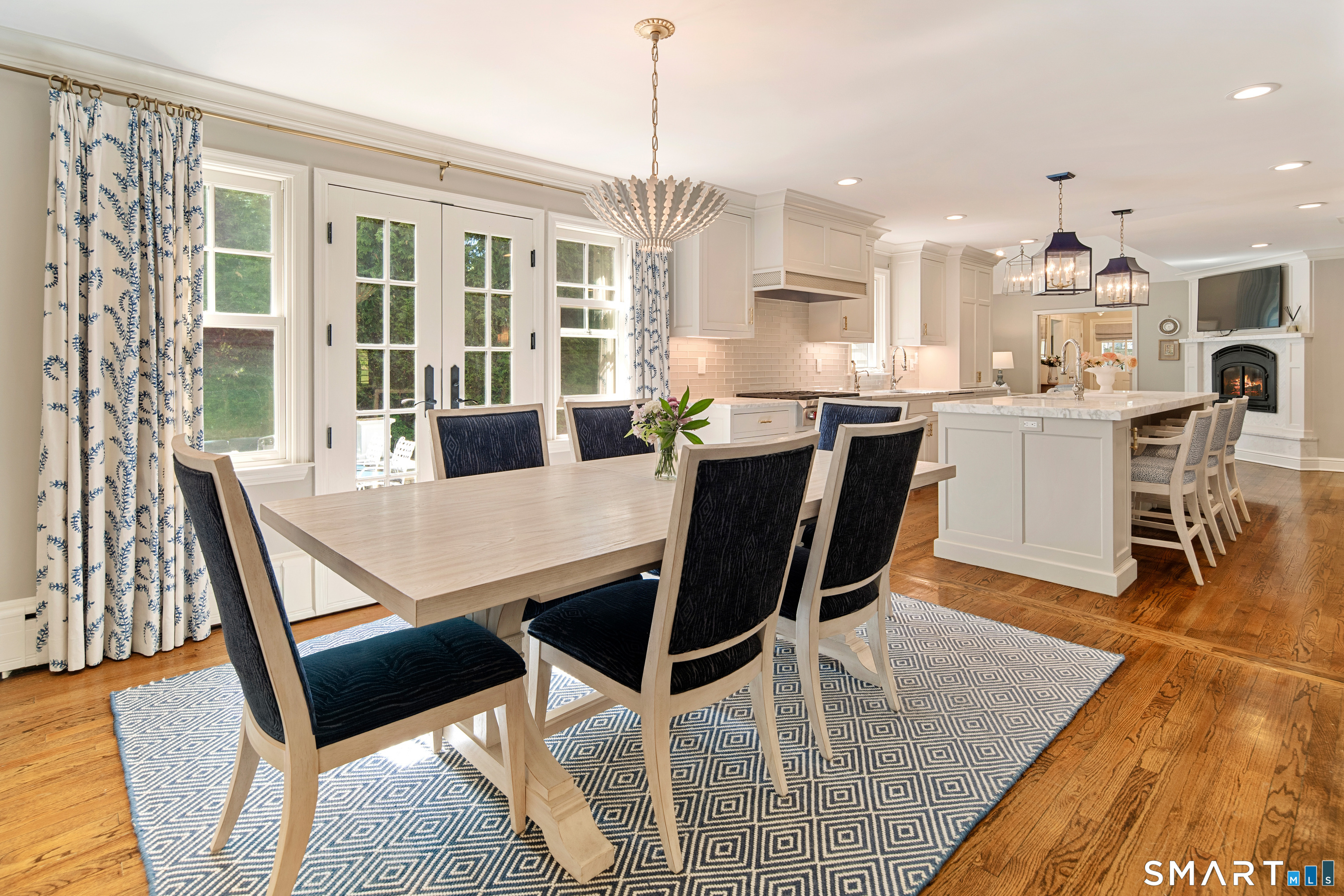 11 McLaren Road South Darien, CT 06820 - Photo 14 of 40 a dining room with wooden floor and large windows