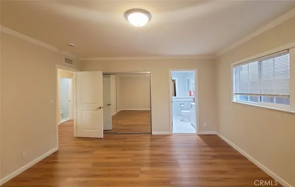 a view of empty room with wooden floor