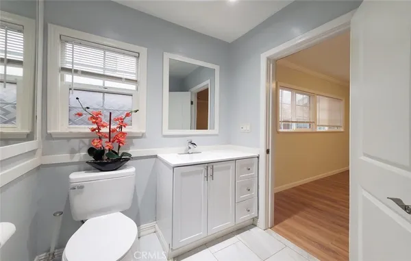 a bathroom with a sink mirror and toilet