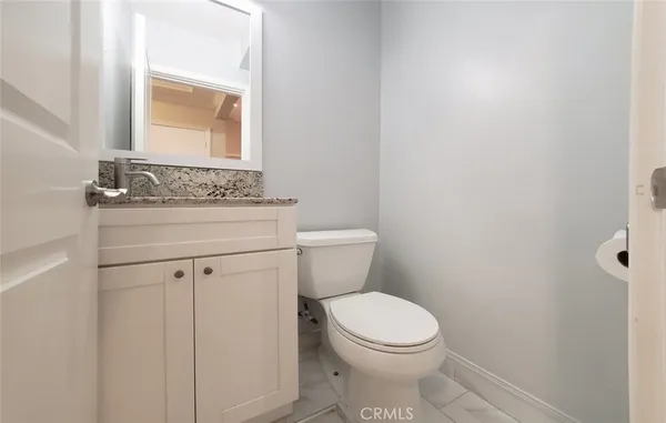 a bathroom with a toilet a sink and a mirror