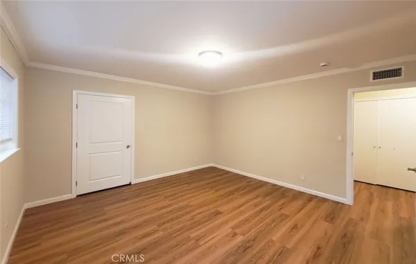 an empty room with wooden floor