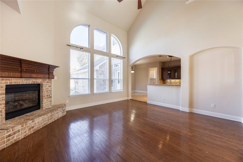 2009 Briarbrook Lane Allen, TX 75002 - Photo 14 of 40 a view of empty room with wooden floor and fireplace