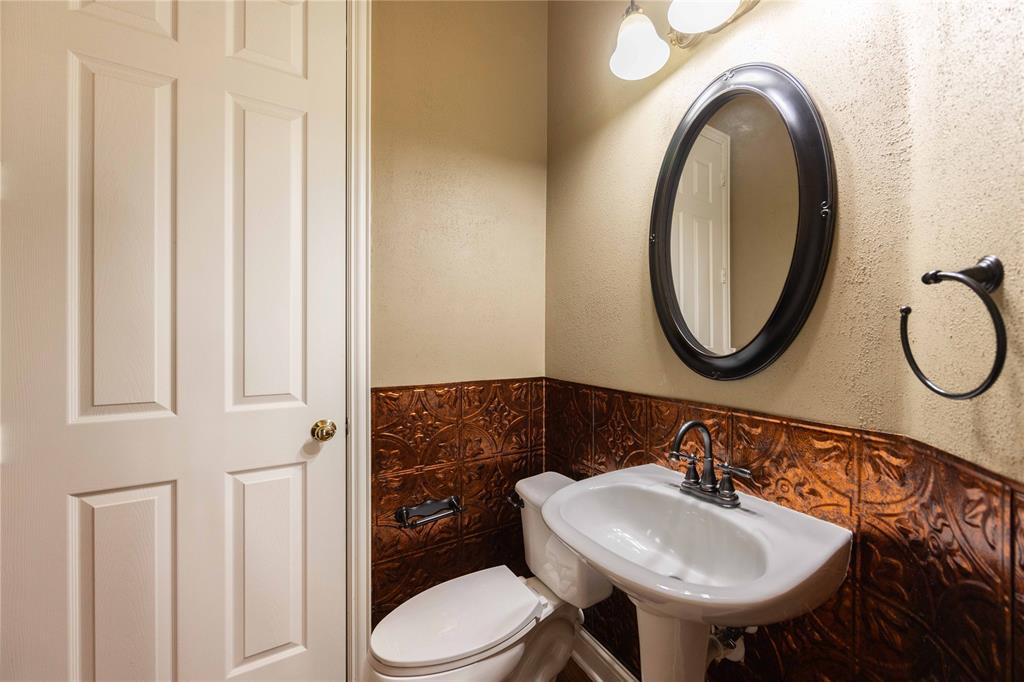 2009 Briarbrook Lane Allen, TX 75002 - Photo 16 of 40 a bathroom with a sink a toilet and a mirror