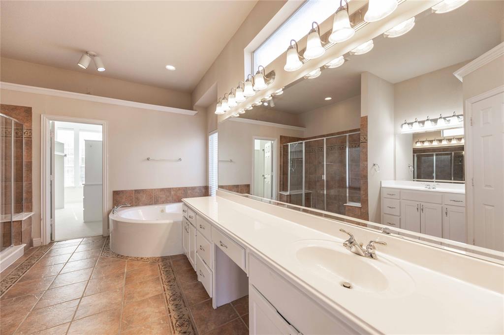 2009 Briarbrook Lane Allen, TX 75002 - Photo 19 of 40 a spacious bathroom with a bathtub sink and mirror