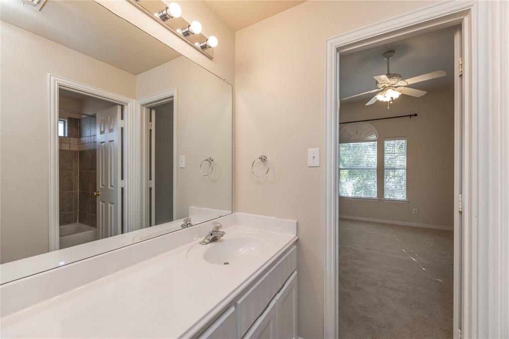 2009 Briarbrook Lane Allen, TX 75002 - Photo 24 of 40 Full bathroom with shower / bathtub combination, carpet, vanity, and a ceiling fan