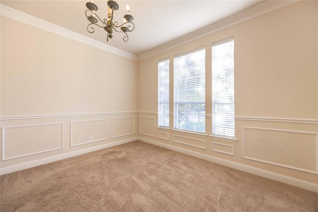 2009 Briarbrook Lane Allen, TX 75002 - Photo 4 of 40 Carpeted spare room with a decorative wall, a chandelier, ornamental molding, and a wainscoted wall