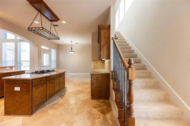 a view of empty room with wooden floor and fireplace