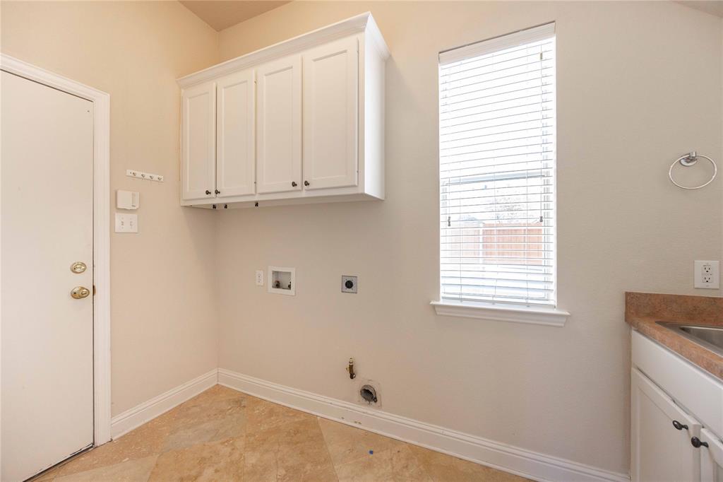 2009 Briarbrook Lane Allen, TX 75002 - Photo 10 of 40 Laundry room with cabinet space, electric dryer hookup, washer hookup, light tile patterned floors, and gas dryer hookup