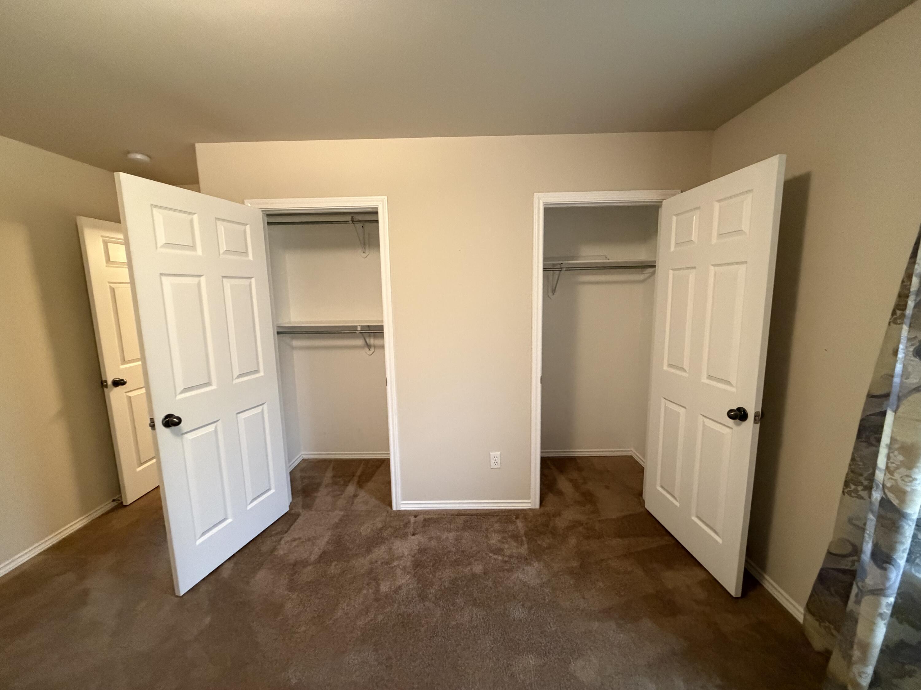 6544 84th Street Lubbock, TX 79424 - Photo 22 of 29 an empty room with a wooden door
