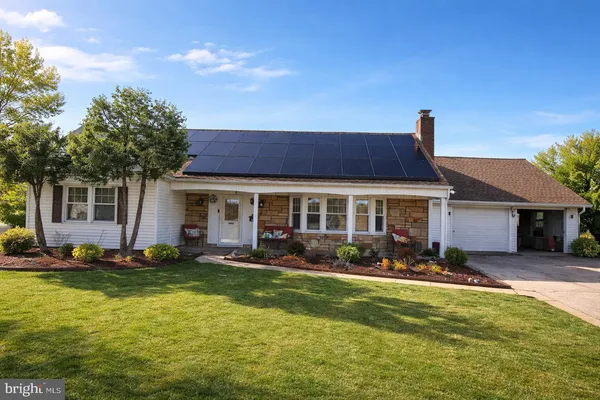 a front view of house with yard and outdoor seating