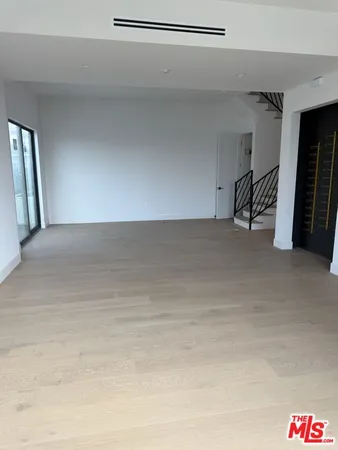 a room with a mirror and a wooden floor