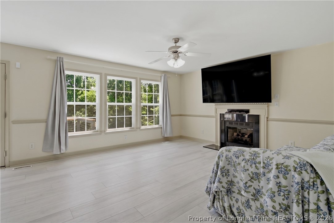 1075 Buffalo Lake Road Sanford, NC 27332 - Photo 13 of 49 a bedroom with a bed and a flat screen tv