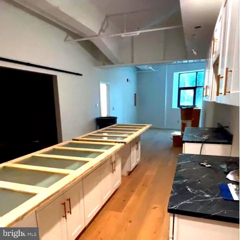 a spacious bedroom with a bed and a flat screen tv