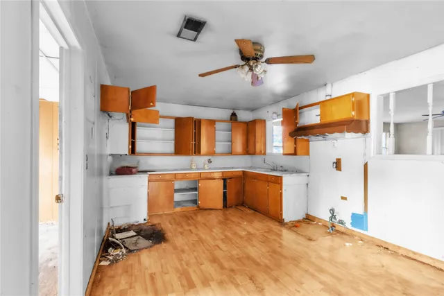 a large white kitchen with a stove a sink and dishwasher