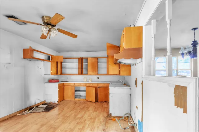 a view of a kitchen with a sink hardwood floor and a window
