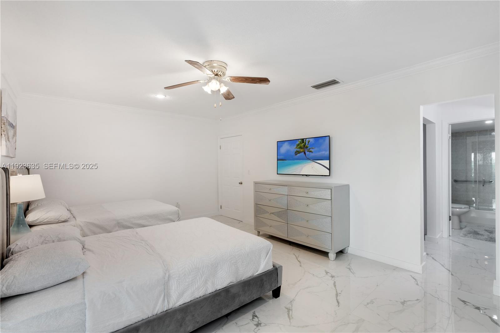 9167 Harding Avenue, Unit 9167 Surfside, FL 33154 - Photo 14 of 45 a bedroom with a bed and cabinet