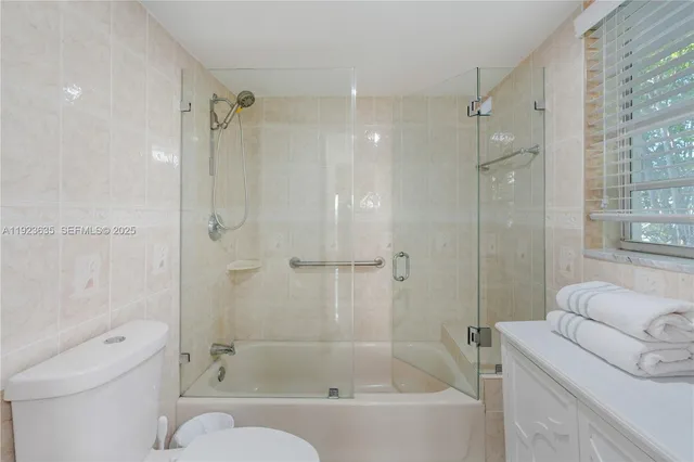 a bathroom with a bathtub toilet and shower