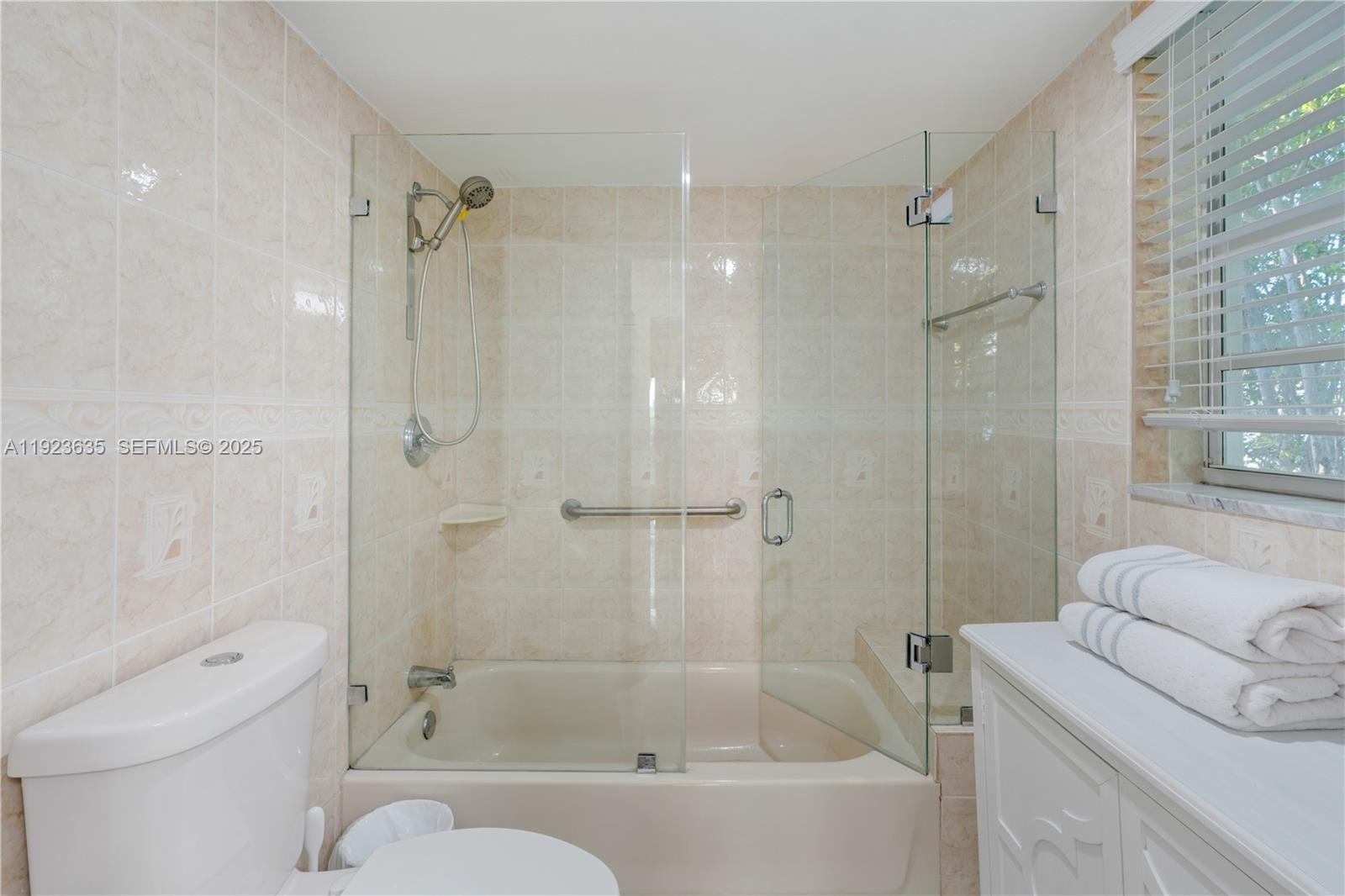 9167 Harding Avenue, Unit 9167 Surfside, FL 33154 - Photo 18 of 45 a bathroom with a bathtub toilet and shower