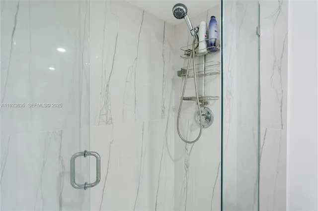 a bathroom with a glass shower door