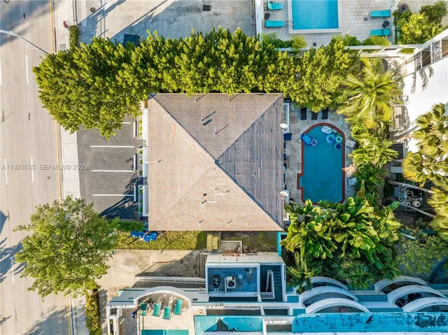 an aerial view of a house with a yard and potted plants