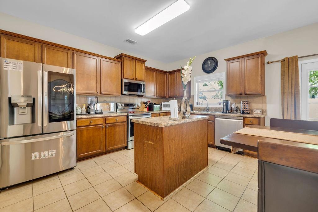 126 Meadow's Walk Drive Byron, GA 31008 - Photo 20 of 37 a kitchen with stainless steel appliances granite countertop a refrigerator a stove top oven and a sink with granite countertops