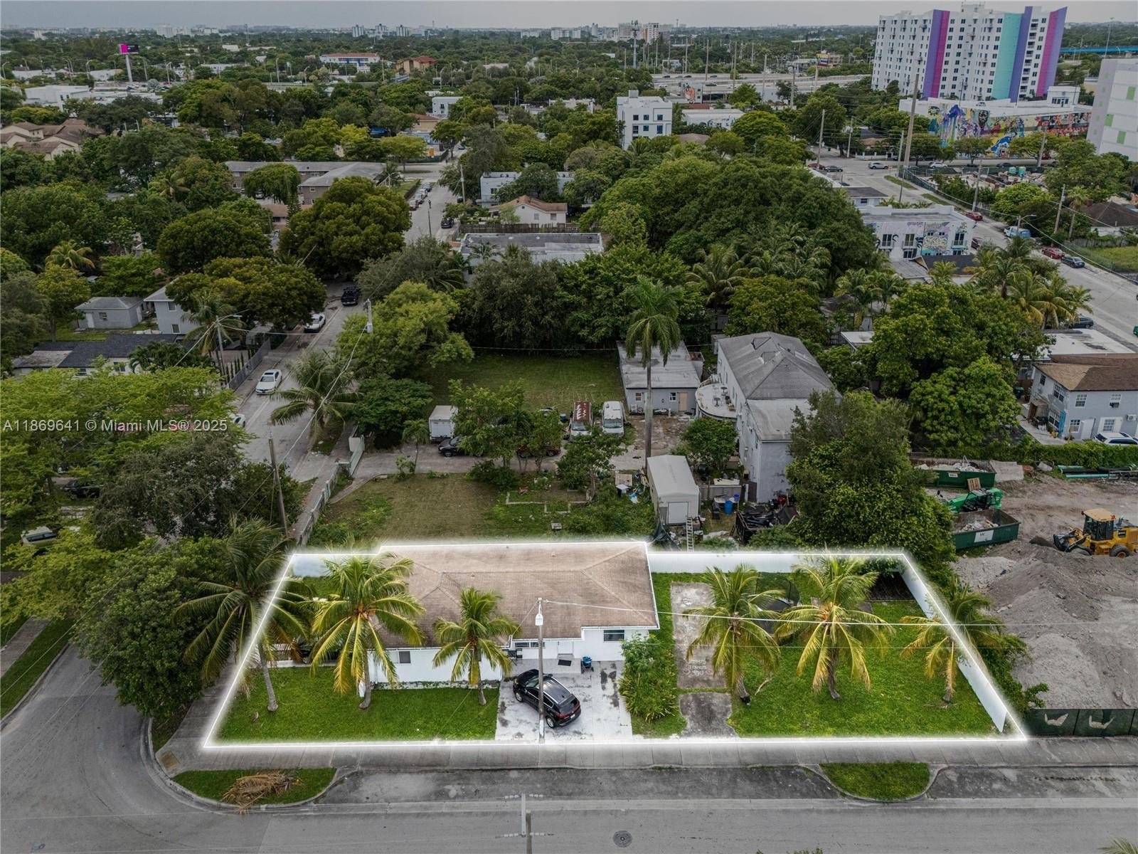 an aerial view of a house with yard swimming pool and lake view