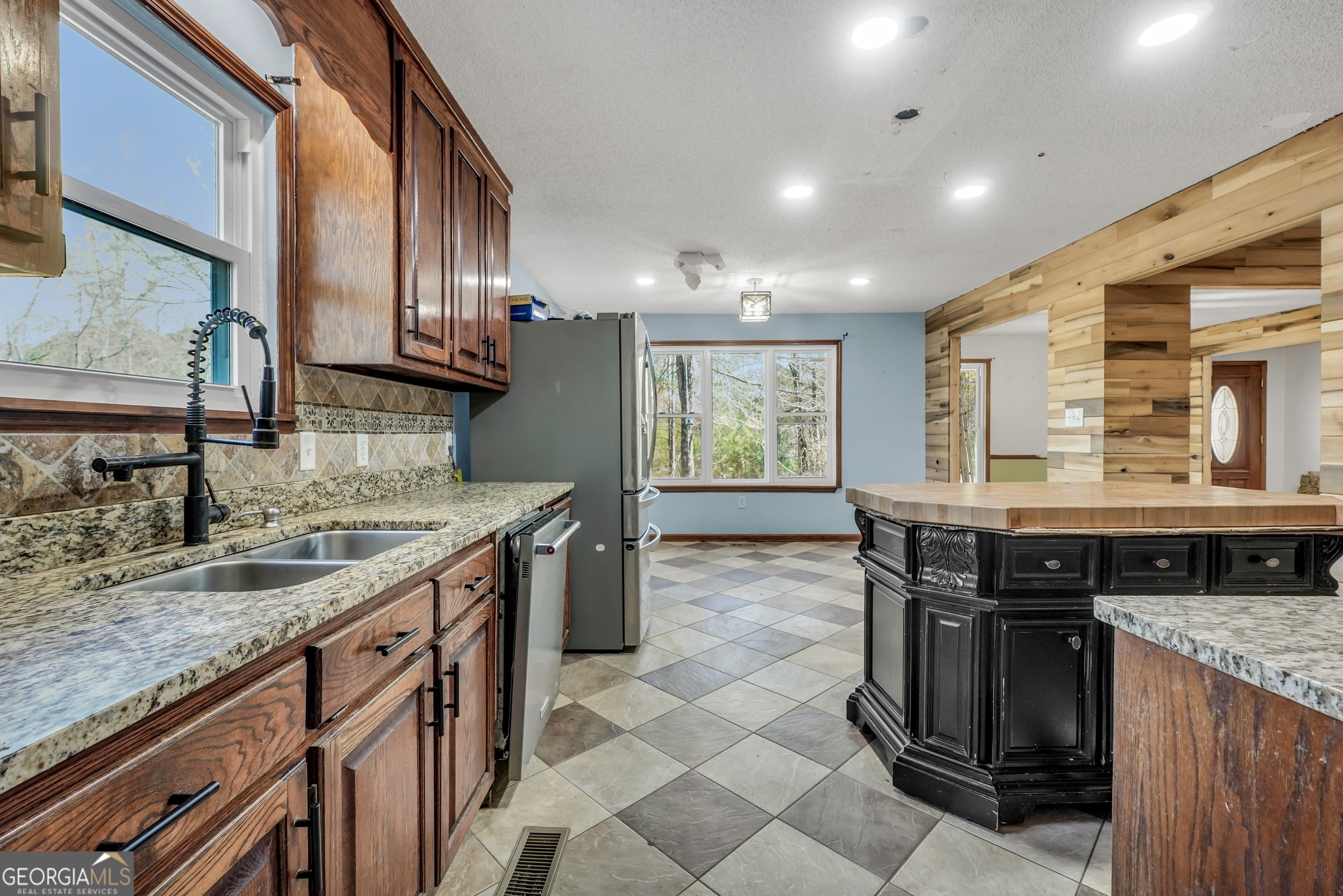 119 Bagley Road Forsyth, GA 31029 - Photo 13 of 36 a kitchen with granite countertop a sink and a stove