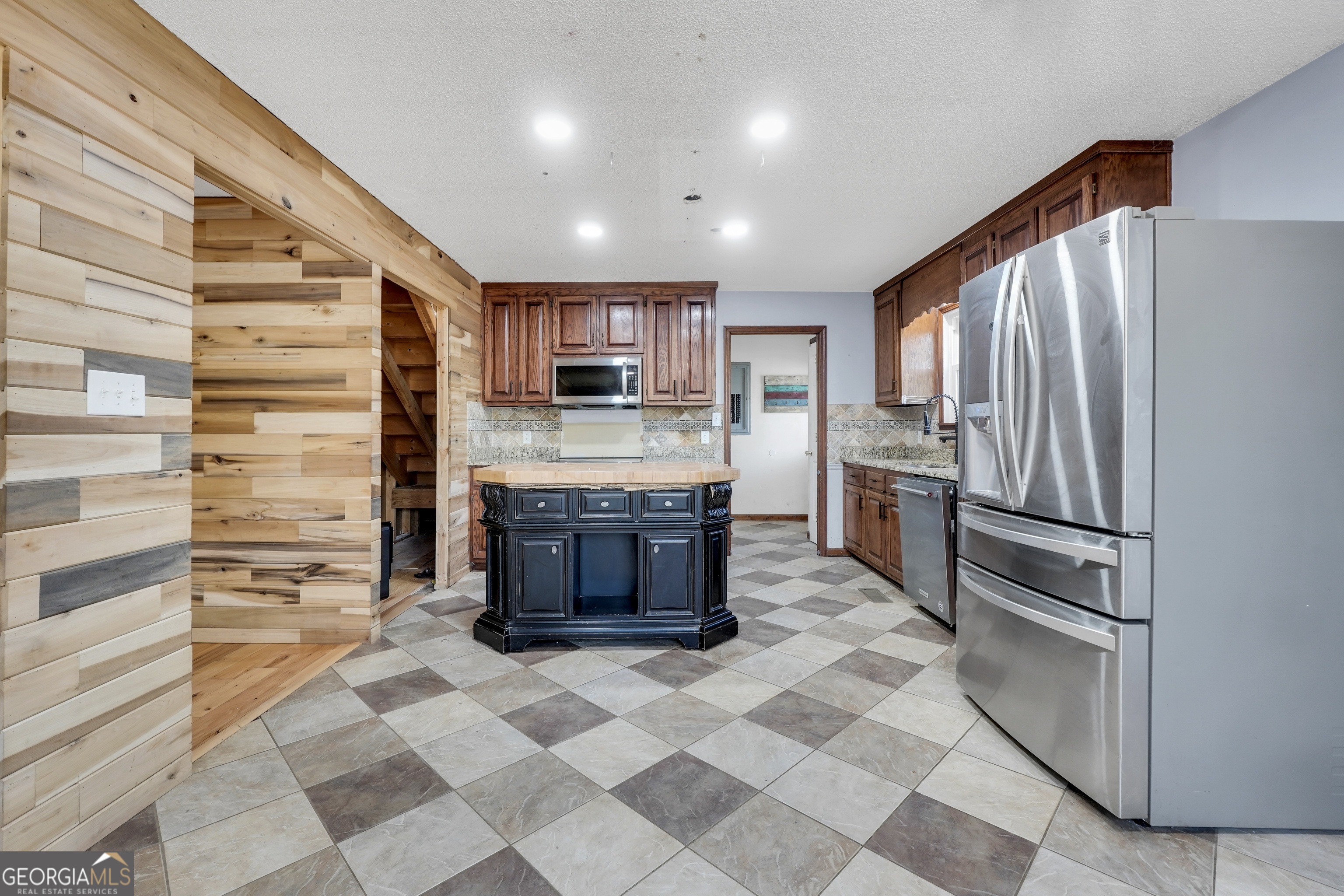 119 Bagley Road Forsyth, GA 31029 - Photo 15 of 36 a kitchen with stainless steel appliances granite countertop a refrigerator and a stove top oven