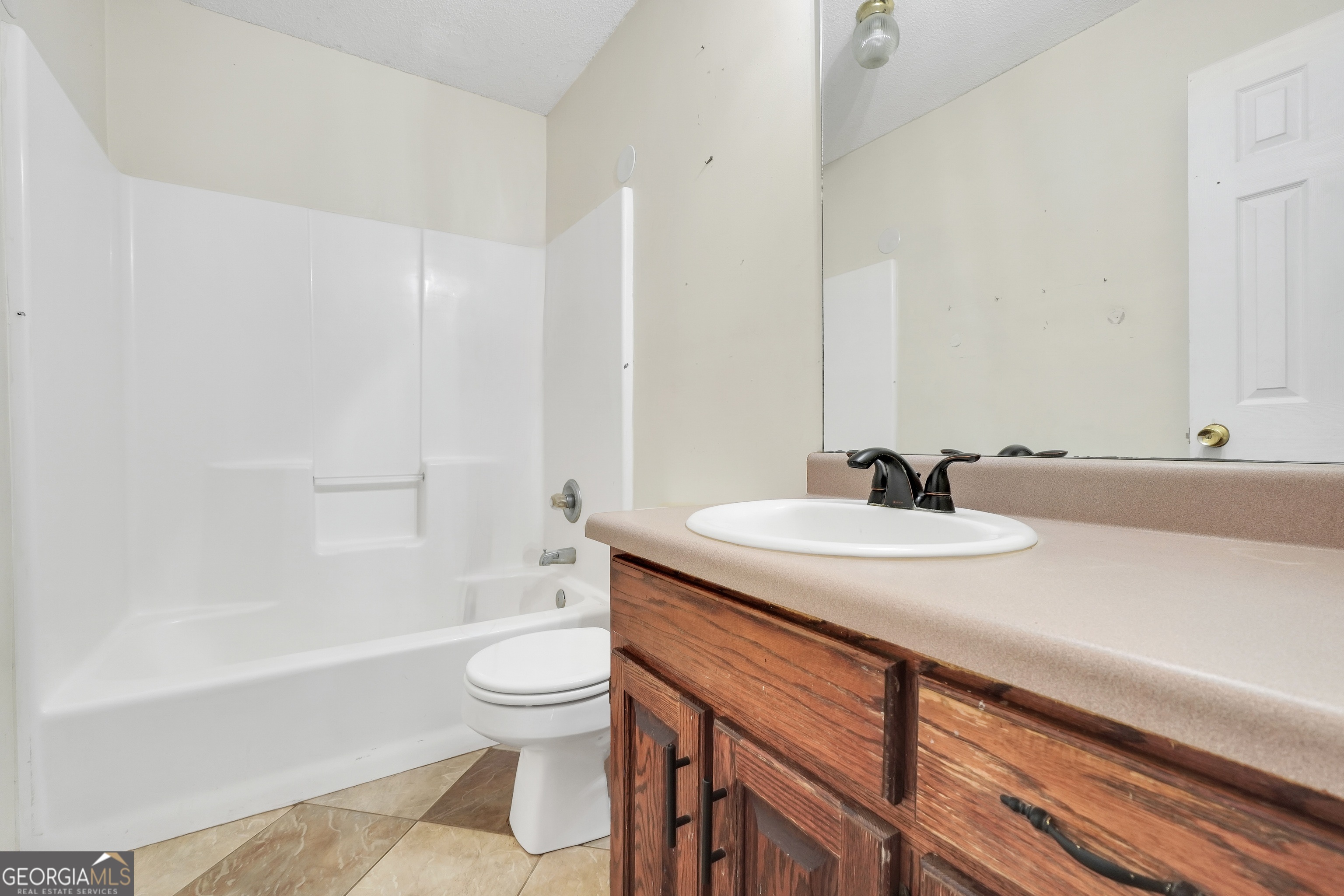 119 Bagley Road Forsyth, GA 31029 - Photo 17 of 36 a bathroom with a granite countertop sink toilet and shower