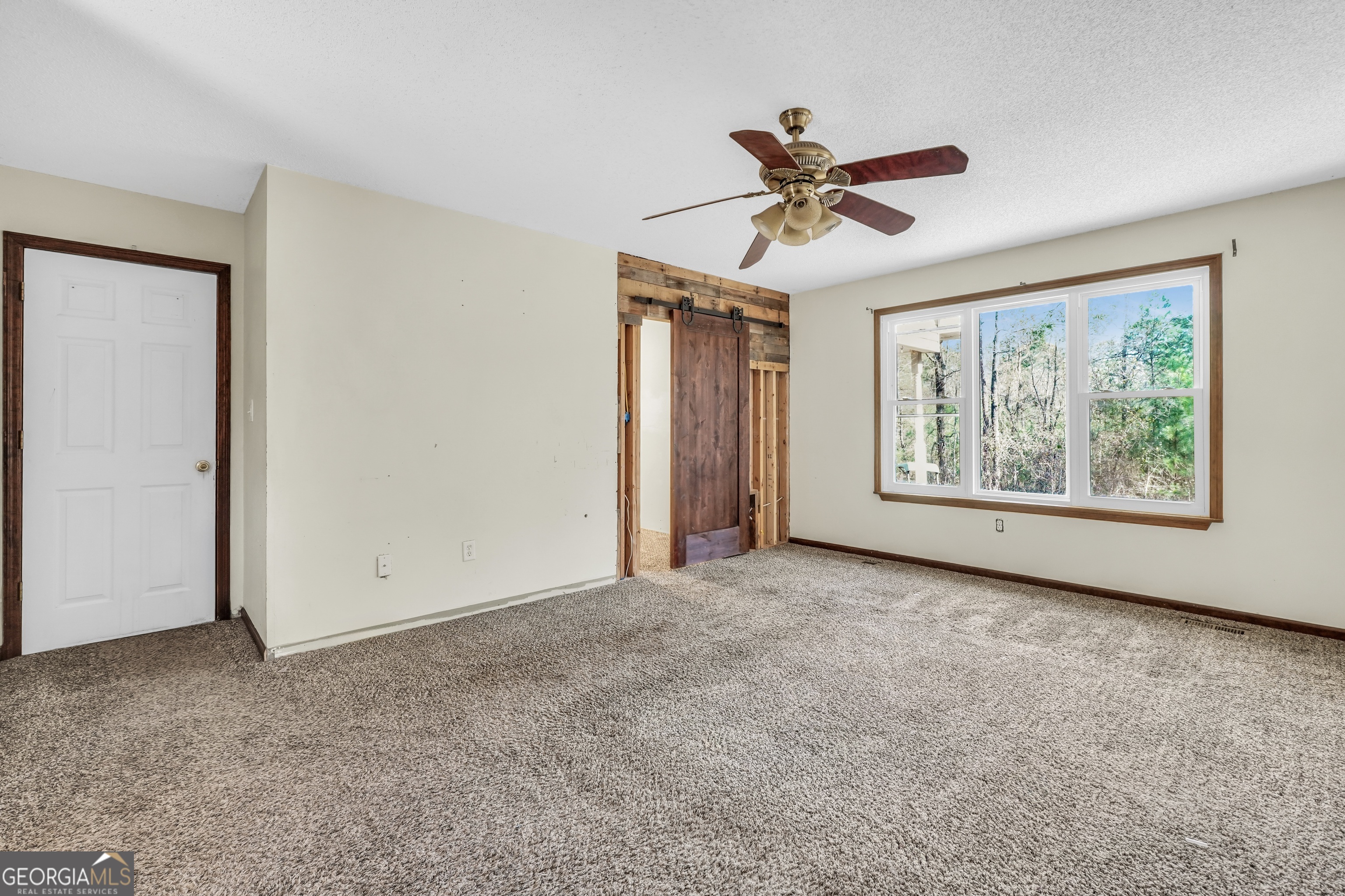 119 Bagley Road Forsyth, GA 31029 - Photo 19 of 36 an empty room with windows and fan