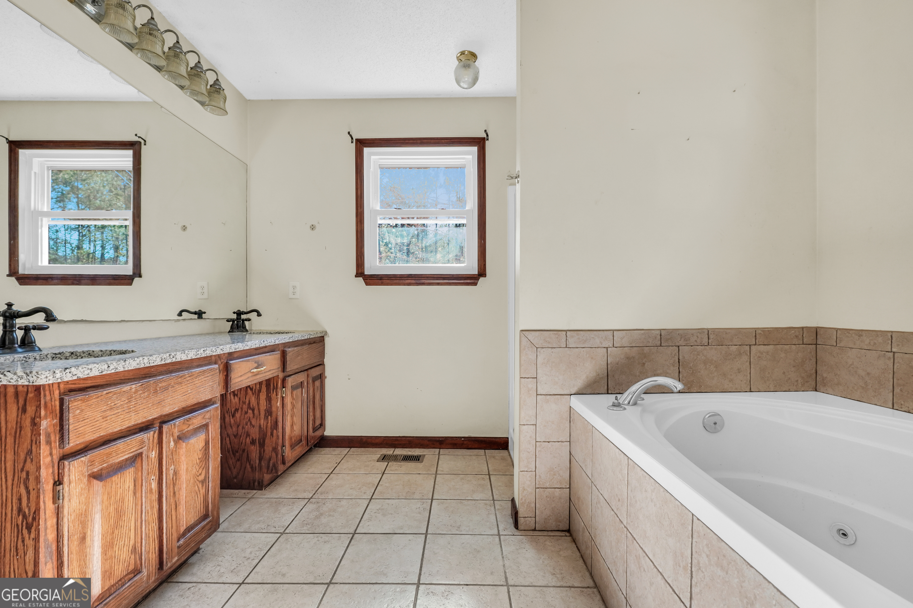 119 Bagley Road Forsyth, GA 31029 - Photo 20 of 36 a bathroom with a bathtub sink and mirror