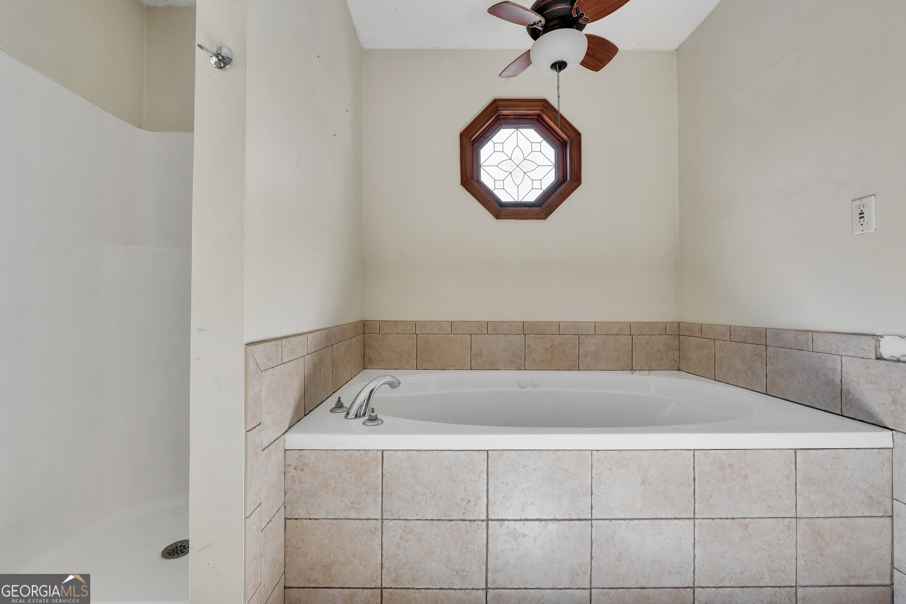 119 Bagley Road Forsyth, GA 31029 - Photo 22 of 36 a bathroom with a bathtub and a window