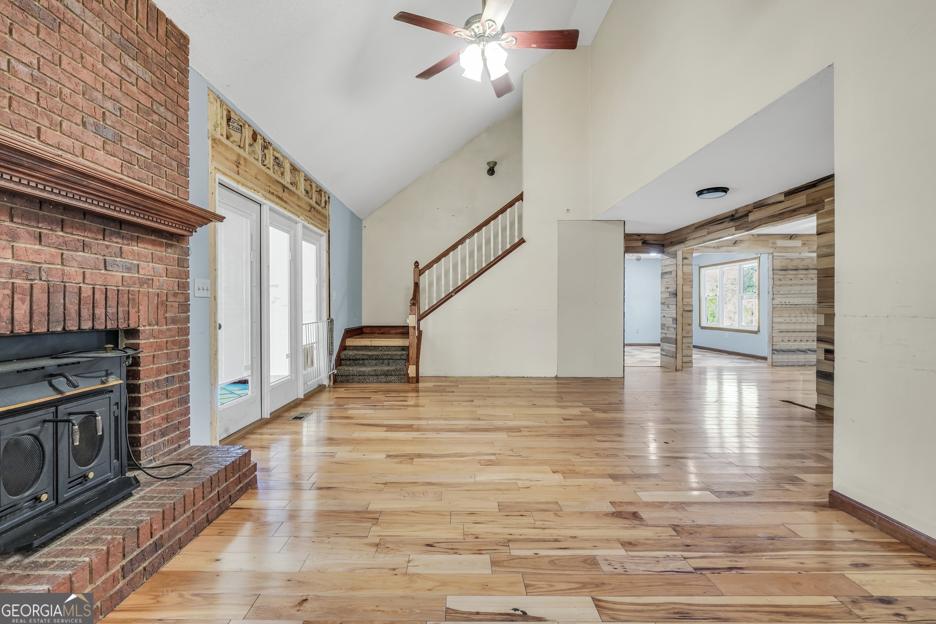 119 Bagley Road Forsyth, GA 31029 - Photo 23 of 36 a view of a livingroom with wooden floor and a ceiling fan