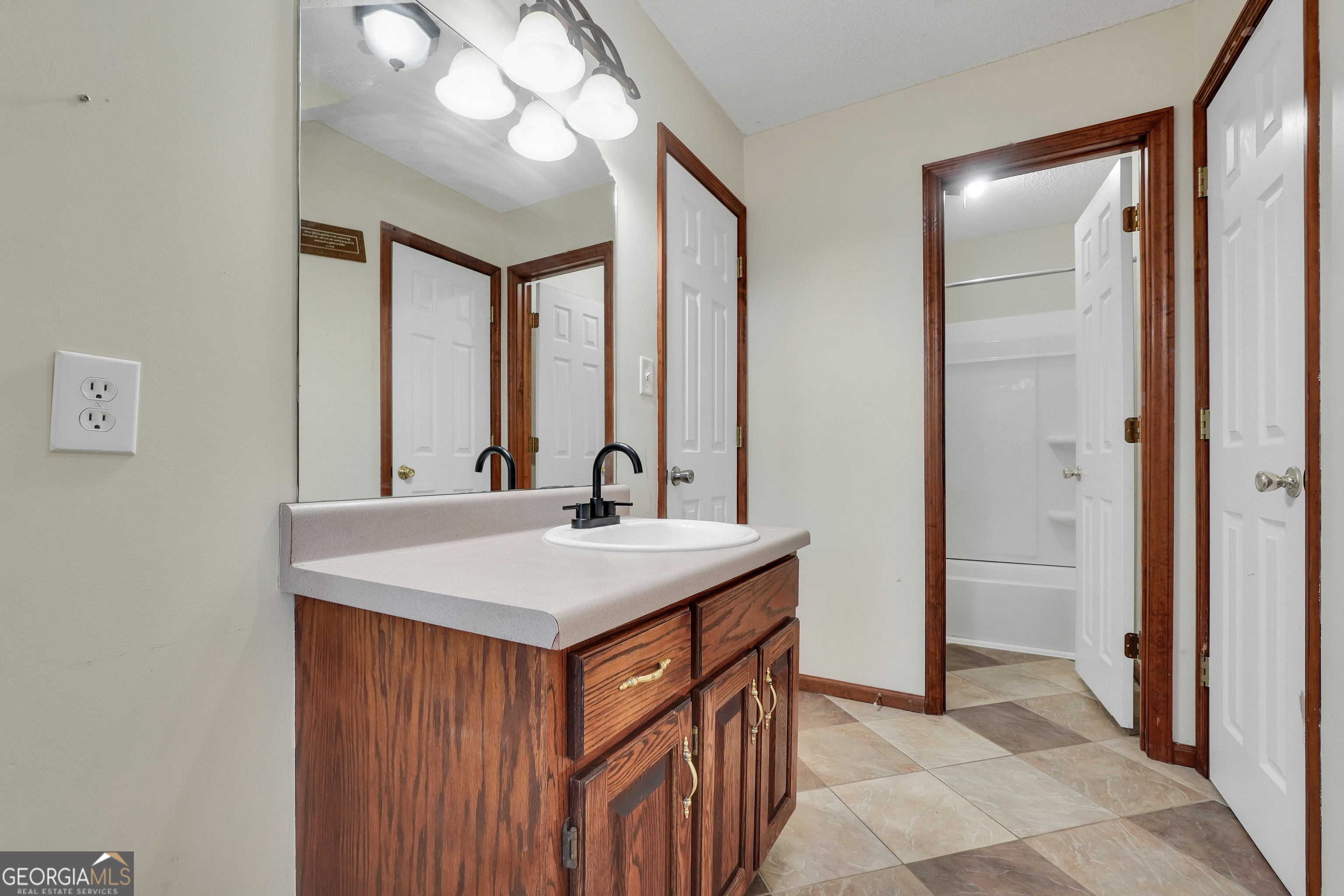 119 Bagley Road Forsyth, GA 31029 - Photo 31 of 36 a bathroom with a sink a vanity and a mirror