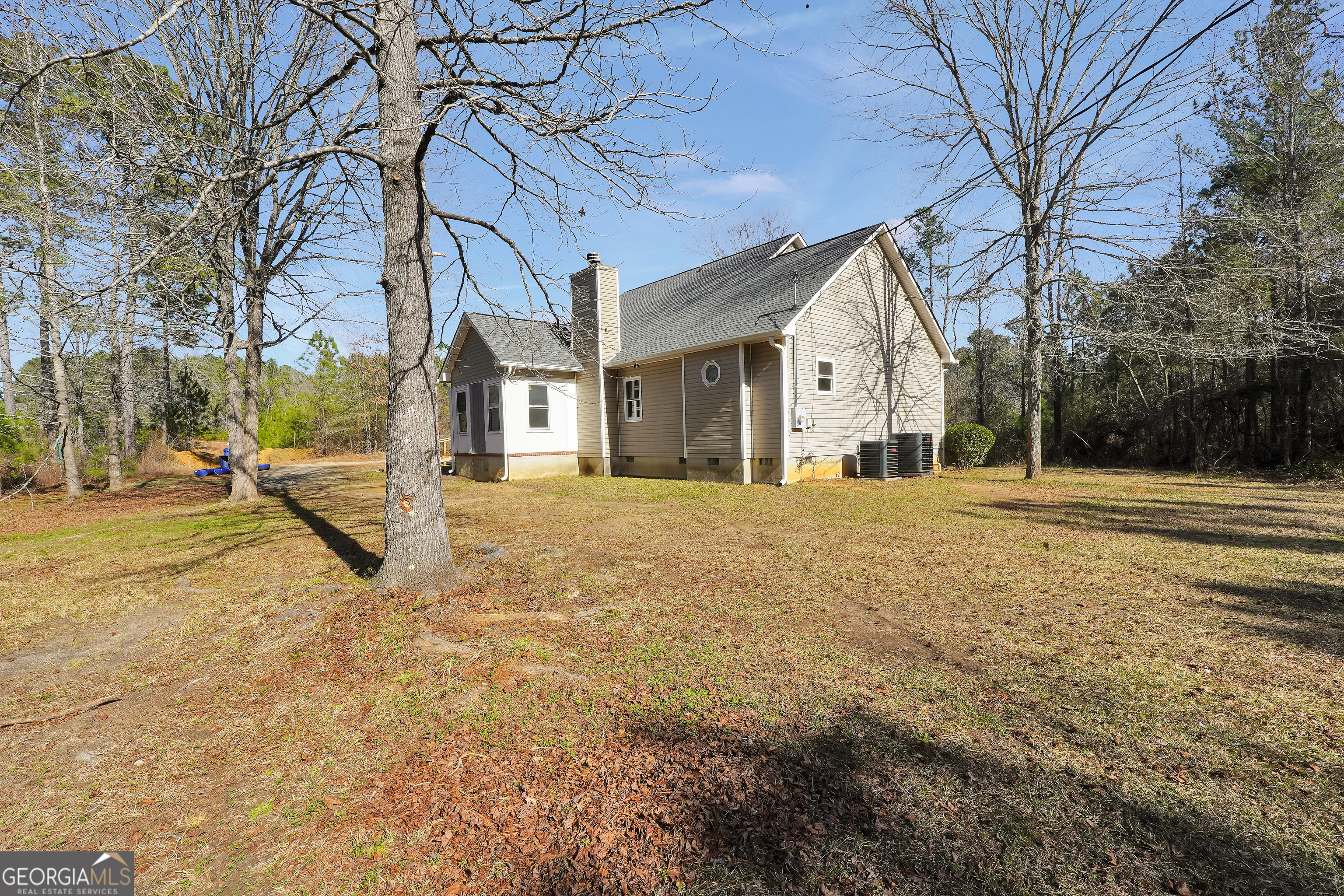 119 Bagley Road Forsyth, GA 31029 - Photo 35 of 36 a yellow house with trees in front of it