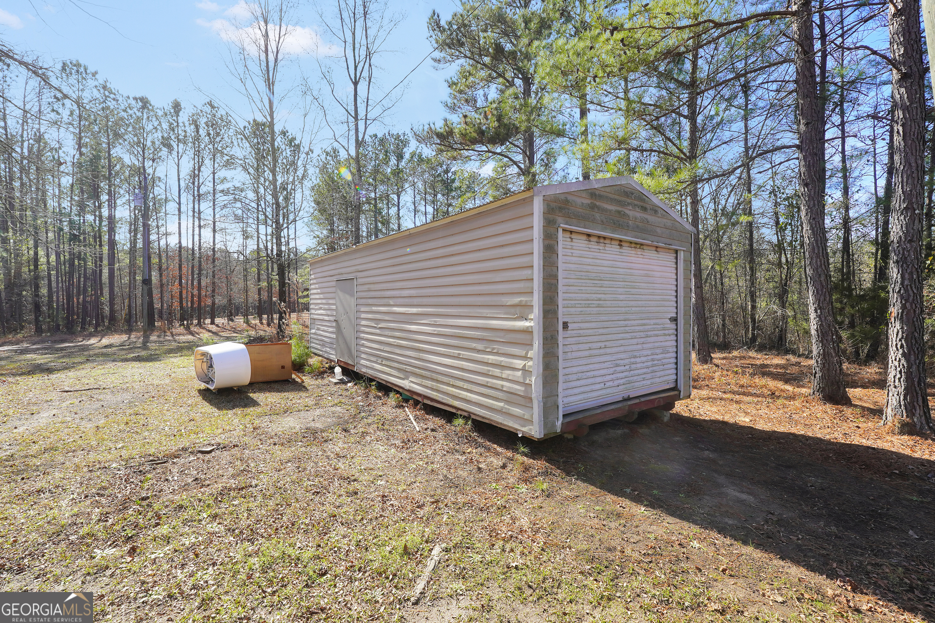 119 Bagley Road Forsyth, GA 31029 - Photo 36 of 36 a view of a back yard of the house with a bench and wooden fence