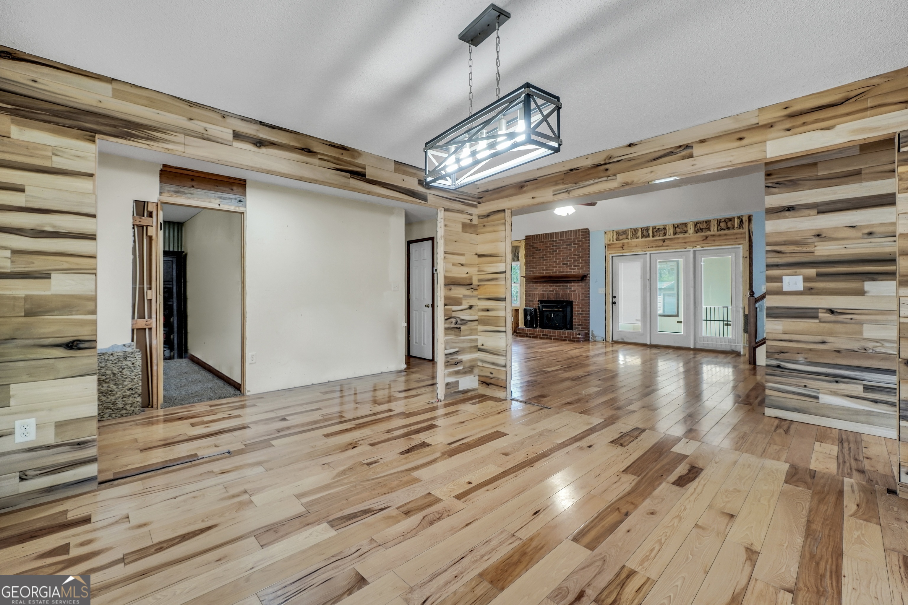 119 Bagley Road Forsyth, GA 31029 - Photo 7 of 36 en empty room with wooden floor chandelier and windows
