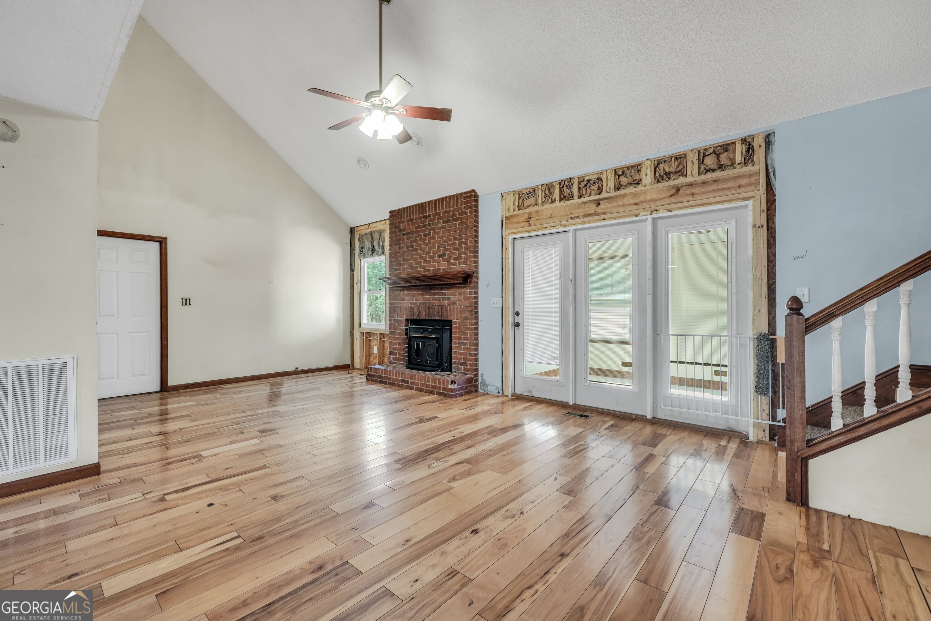 119 Bagley Road Forsyth, GA 31029 - Photo 8 of 36 a view of an empty room with wooden floor fireplace and a window