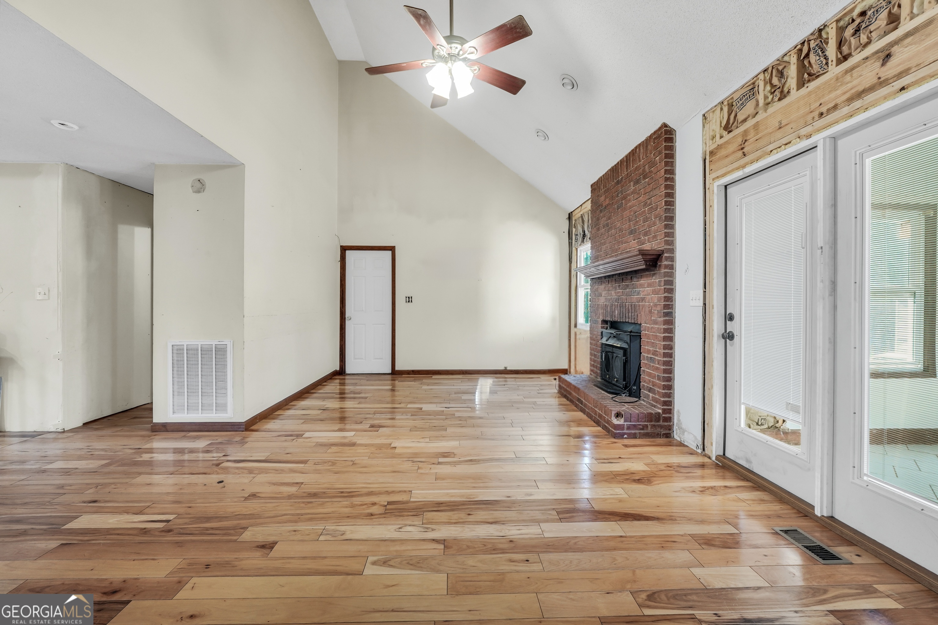 119 Bagley Road Forsyth, GA 31029 - Photo 9 of 36 a view of empty room with wooden floor and fan