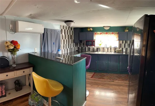 a kitchen with cabinets and a wooden floor