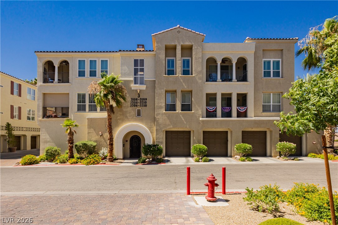 2555 Hampton Road, Unit 3308 Henderson, NV 89052 - Photo 3 of 65 A warm stucco exterior frames balconies and attached garages, offering inviting curb appeal.