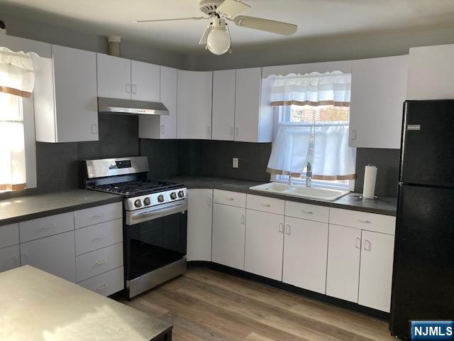 129 Union Street Hackensack, NJ 07601 - Photo 2 of 10 a kitchen with granite countertop a sink stainless steel appliances and window
