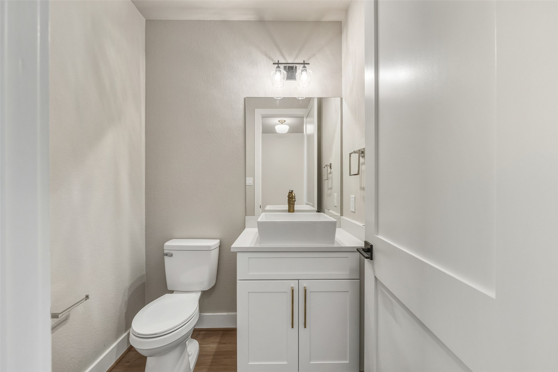 3424 Elser Street Houston, TX 77009 - Photo 24 of 36 a bathroom with a toilet a sink and mirror