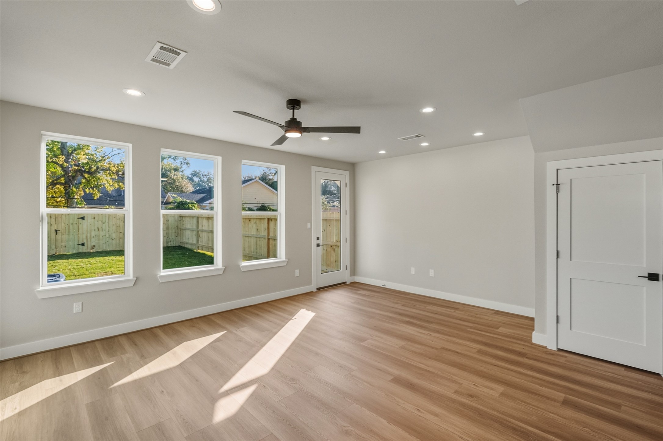 3424 Elser Street Houston, TX 77009 - Photo 5 of 36 a view of an empty room with a window and wooden floor