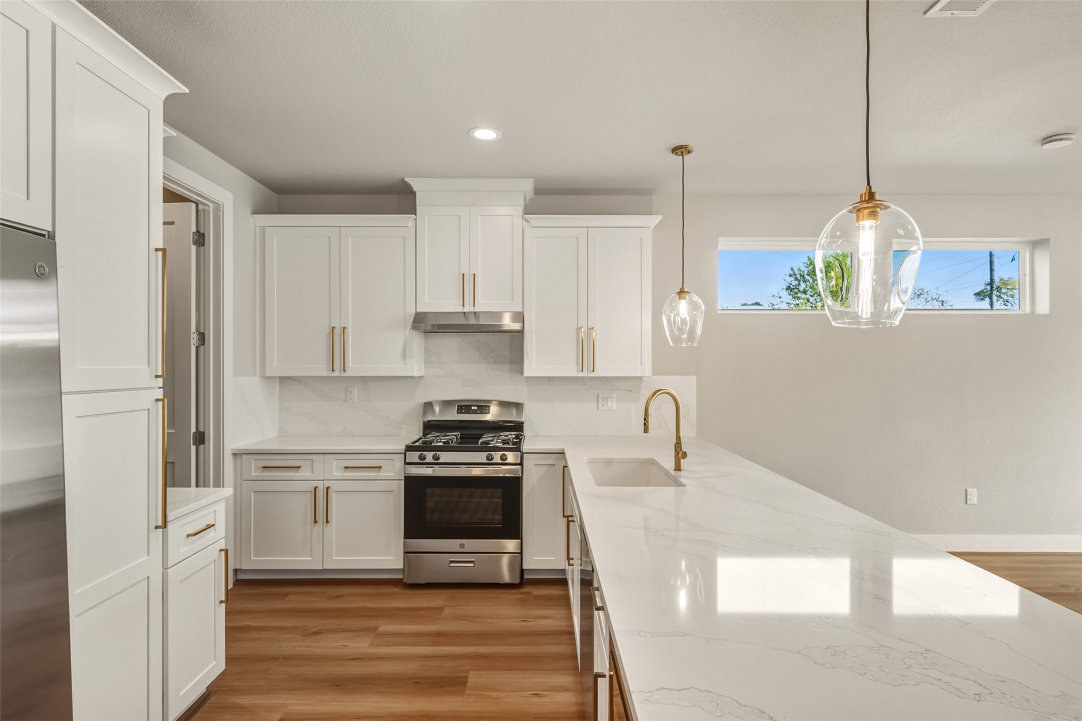 3424 Elser Street Houston, TX 77009 - Photo 8 of 36 a kitchen with stainless steel appliances granite countertop a sink a stove and a refrigerator