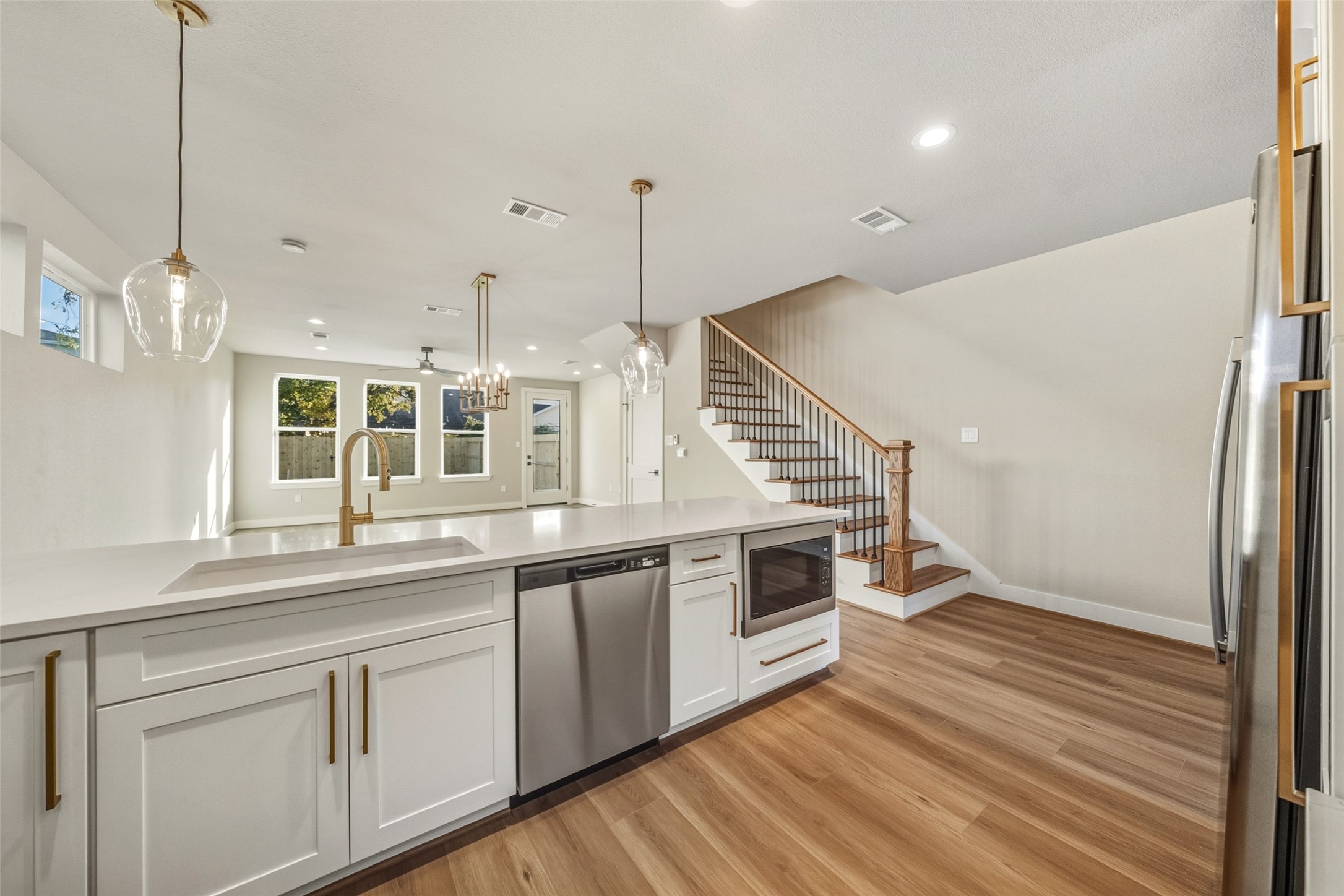3424 Elser Street Houston, TX 77009 - Photo 9 of 36 a kitchen with stainless steel appliances granite countertop a sink a stove and a wooden floors