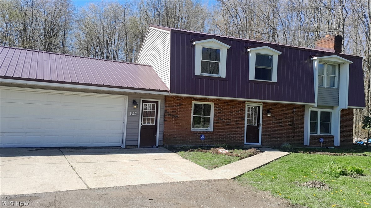 6970 Bushnell Road Conneaut, OH 44030 - Photo 1 of 28 View of front facade with a garage