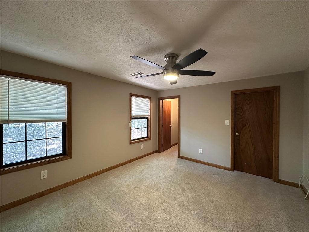 710 Spiva Road Temple, GA 30179 - Photo 19 of 31 an empty room with windows and ceiling fan