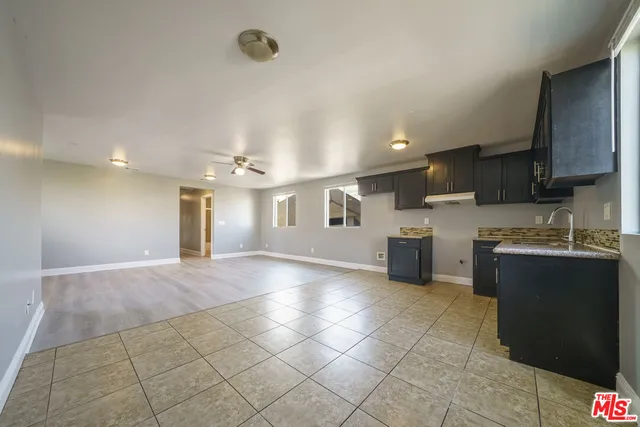 a kitchen with stainless steel appliances granite countertop a sink a stove top oven and cabinets