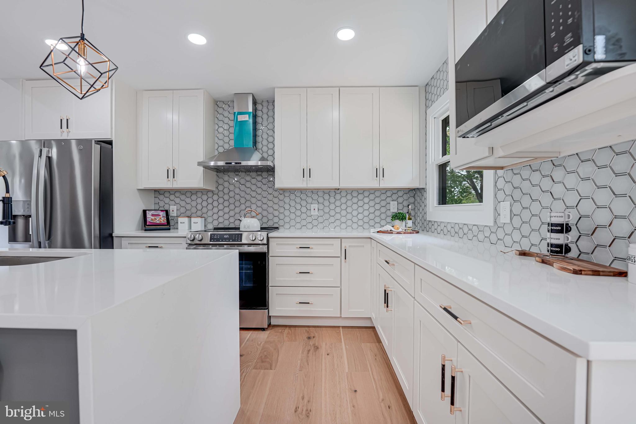 8643 Gateshead Road Alexandria, VA 22309 - Photo 11 of 40 a kitchen with granite countertop a sink stainless steel appliances and cabinets